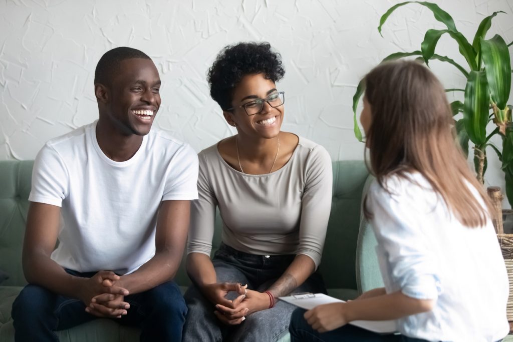 Happy couple with medical professional explaining their billing options